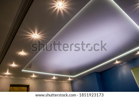Beautiful stretch ceiling with led lighting, spotlights around the perimeter. Royalty-Free Stock Photo #1851923173