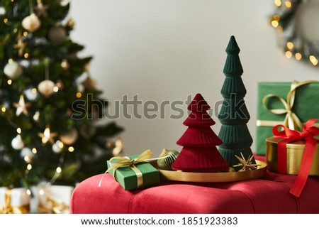 Christmas composition with decoration, christmas tree, gifts and accessories in cozy home decor. Copy space. White and red. Template.