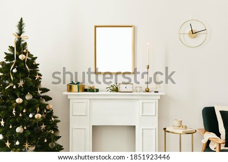Christmas composition with gold mock up poster frame, white chimney and decoration. Christmas trees and wreath, candles, stars, light and elegant accessories. Template.