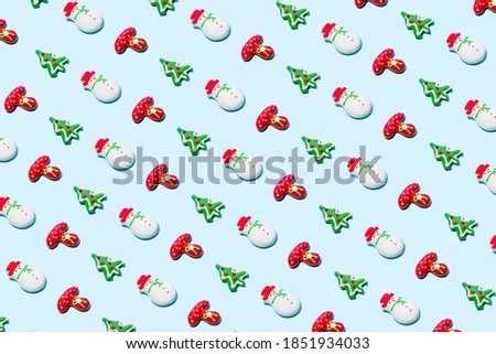 Christmas decorations on the blue backdrop. New Year and Holidays card. Minimal style. Christmas pattern. Flat lay, top view, copy space.