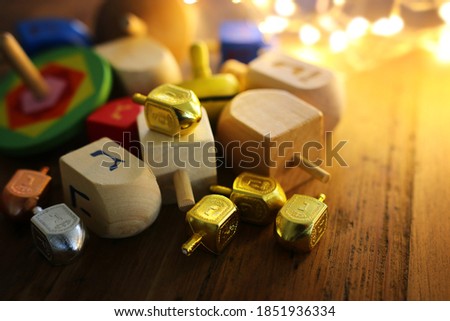 Banner of jewish holiday Hanukkah with wooden dreidels (spinning top) over wooden background