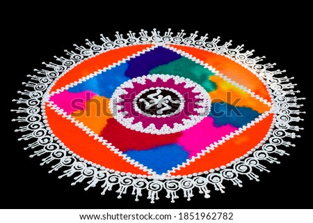 Rangoli isolated with black background. The color powder used to make this art work during hindu festivals such as diwali, Navaratri etc. This rangoli is known as Sanskar Bharati.