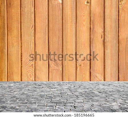 wooden fence rough background and vintage stone pavement foreground