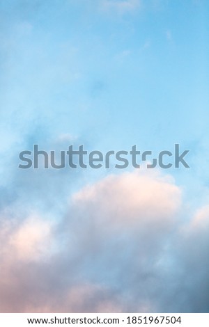 sunset blue sky with pink peach fluffy clouds
