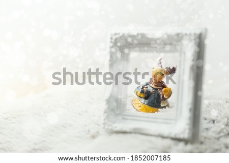 Happy reindeer with santa claus suit looking through empty picture frame.Merry Christmas and happy new year concept background.