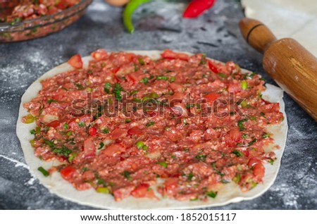 Traditional Turkish pizza (lahmacun) is ready to cook on the table.