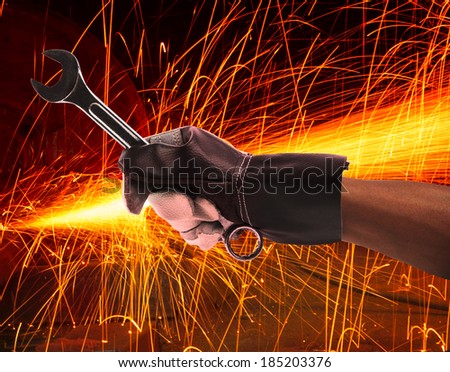 hand of worker man working by leather hand glove protection heat of splashing fire in heavy industry factory use for metal and iron industrial manufacturing theme 