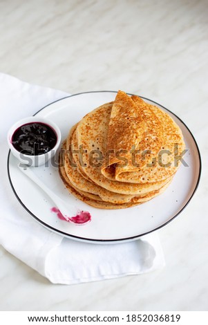 
Fresh baked french crepes or Russians blinis on beautiful plate.