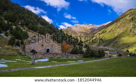 Autumn picture of Vall de Nuria - sanctuary and ski resort in Catalan Pyrenees - on sunny day, blue sky with single white clouds