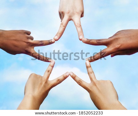 Black and white people forming five pointed star with their fingers. Royalty-Free Stock Photo #1852052233