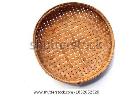 Wicker tray or bamboo basket is Thailand people handmade and old culture isolated on white background closeup. Royalty-Free Stock Photo #1852052320