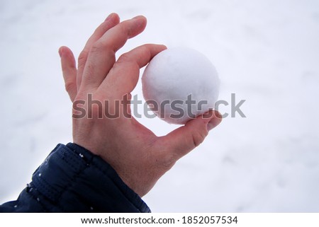 snowball in bare hand. snowball melts in bare hand