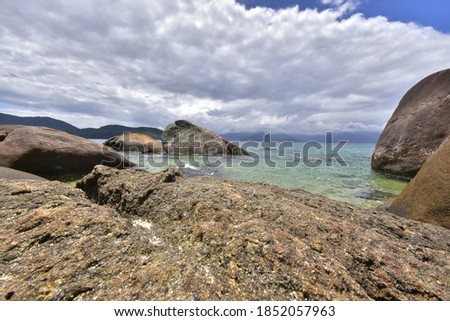 Between the waters of the sea and the rocks, the landscape of the beach of Feiticeira, one of the many beaches of Ilha Grande, city of Angra dos Reis, Rio de Janeiro, Brazil