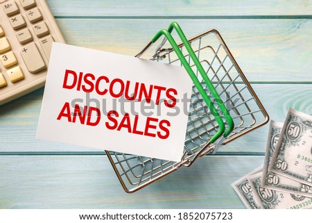 Shopping basket and text DISCOUNTS SALE on white paper note list. Shopping list concept.