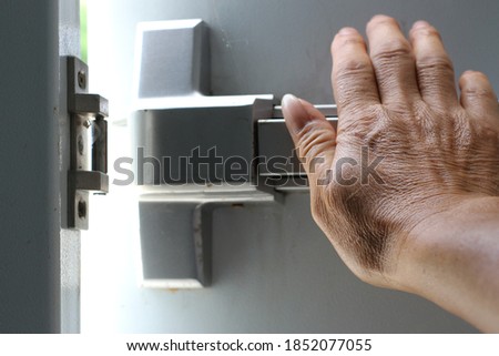 Hand pushing on the fire door.Get away as quickly as possible.