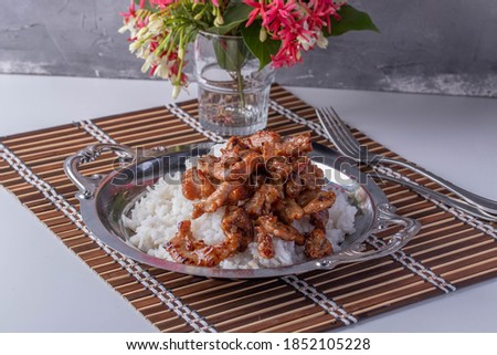 Fried Garlic and Pepper Pork on a Metal Plate