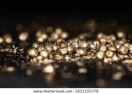 Shining golden particles abstract background. Blurred bokeh background of gold dust particles slowly floating in the air. Magical fairy background. festive golden dark background.