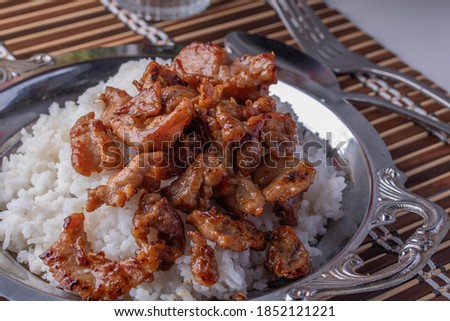 Fried Garlic and Pepper Pork on a Metal Plate