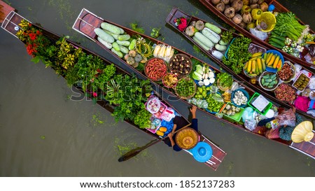 Aerial view famous floating market in Thailand, Damnoen Saduak floating market, Farmer go to sell organic products, fruits, vegetables and Thai cuisine, Tourists visiting by boat, Ratchaburi, Thailand Royalty-Free Stock Photo #1852137283