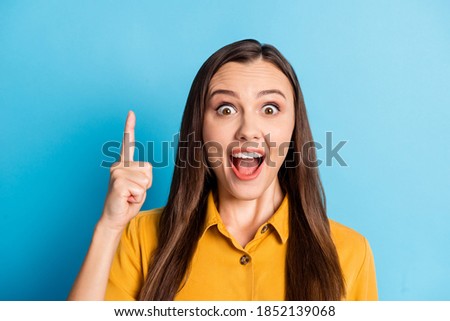 Photo of positive pretty lady have solution direct finger up open mouth isolated on blue color background