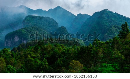 Morning fog adorns the sidelines of the hills on the slopes of Mount Merapi, Yogyakarta, Indonesia.