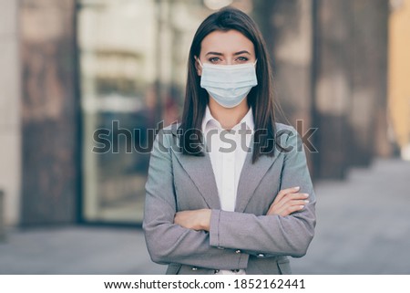 Photo of serious beautiful business lady crossed hands wear respiratory mask epidemic look job outside in city outdoors Royalty-Free Stock Photo #1852162441