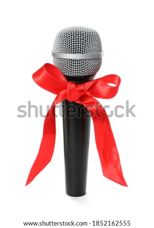 Microphone with red bow isolated on white. Christmas music