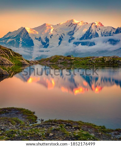 Wonderful summer sunset on Lac Blanc lake with Mont Blanc (Monte Bianco) on background, Chamonix location. Magnificent outdoor scene of Vallon de Berard Nature Preserve, Graian Alps, France.  Royalty-Free Stock Photo #1852176499