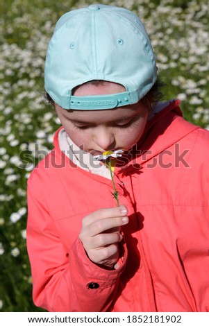 Young girl on the background of flowers field