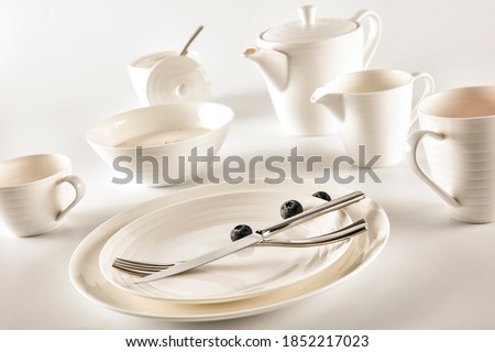 A set of white ceramic breakfast utensils