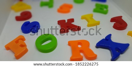 Close up of Multicolour alphabet  fridge letters isolated on white background
