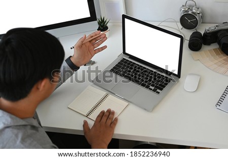 Overhead shot of graphic designer or photographer is working with computer laptop on white table.