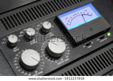 Rack audio compressor of sound recording studio close up. Making music in the professional studio. VU meter close up.