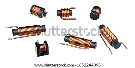 Set of solenoid coils with black ferrite core isolated on white background. Close-up of cylindric inductors with helical copper wire winding. Group of electronic components. Electromagnetic induction. Royalty-Free Stock Photo #1852244098
