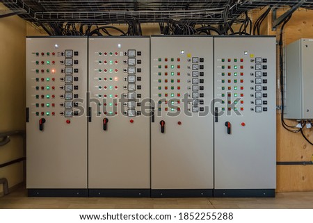 Electrical switchgear cabinets with control panels with indicator lights in factory. Royalty-Free Stock Photo #1852255288