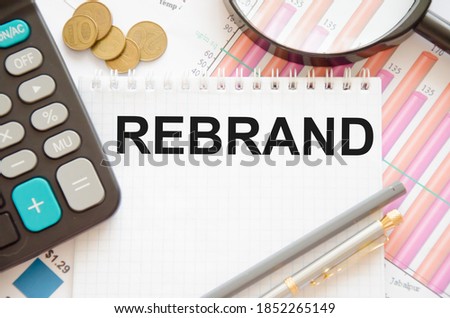 the word rebranding is written on a notepad on financial charts. marketing idea. High quality photo