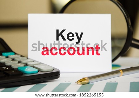 the word key account is written on a white sheet of paper on the back of a calculator and notepad. Business concept for a personalized sales approach showing your customers. High quality photo