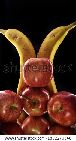 This is a picture of tropical fruits. They are apples and bananas. 