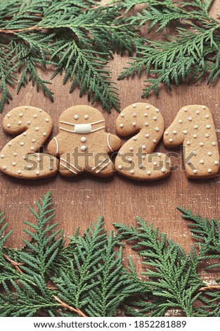 Coronavirus 2021 gingerbreads on wooden background 