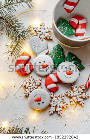 Christmas gingerbread mini cakes in a mug: tree, snowman, snowflakes, mittens.
White
background, composition for postcards.