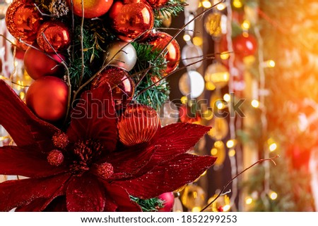 Christmas and New Year holidays bokeh light background with red apple and pine cone.