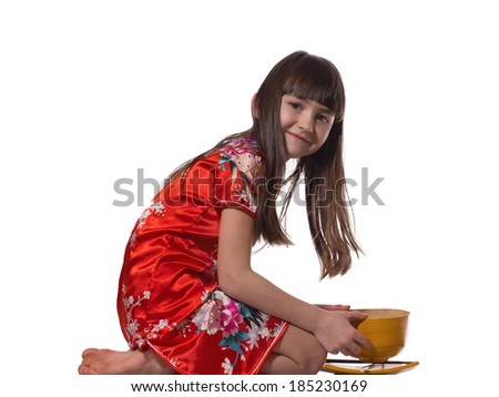 Portrait of caucasian little girl in vietnamese national costume keep wooden bowl and plate isolated on white