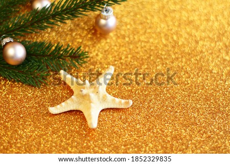 Tropical Christmas decoration, sea star and fur tree on glitter gold background, New Year festive congratulation card with tropic details	