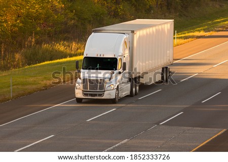 18 wheeler semi truck driving down the road. Royalty-Free Stock Photo #1852333726