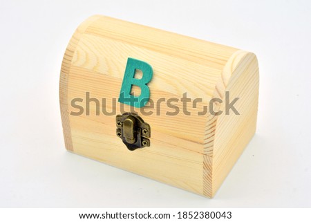 Closed wooden chest, with the letter B on the lid