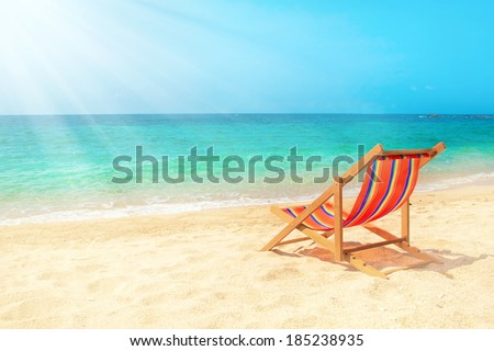 Lounge chair n the beach Royalty-Free Stock Photo #185238935