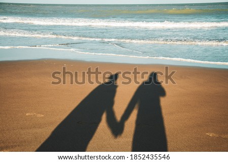 couple shadow on the sand on the beach