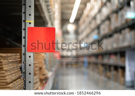 Racking shelf 's label plate with empty copy space that use to label a product detail or row number. Placed in the factory warehouse store. Sign/symbol and industrial business photo. 