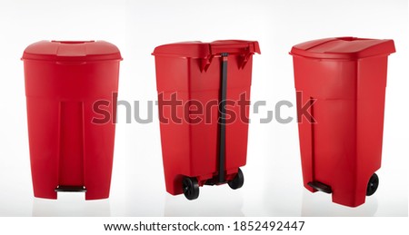 A picture of a large red rubbish bin with wheels on