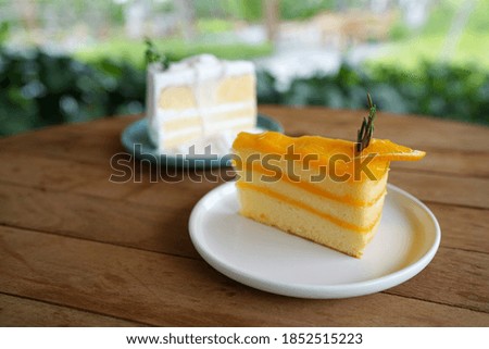 Orange cake - A plate of homemade orange cake with candied orange slices on wooden table.